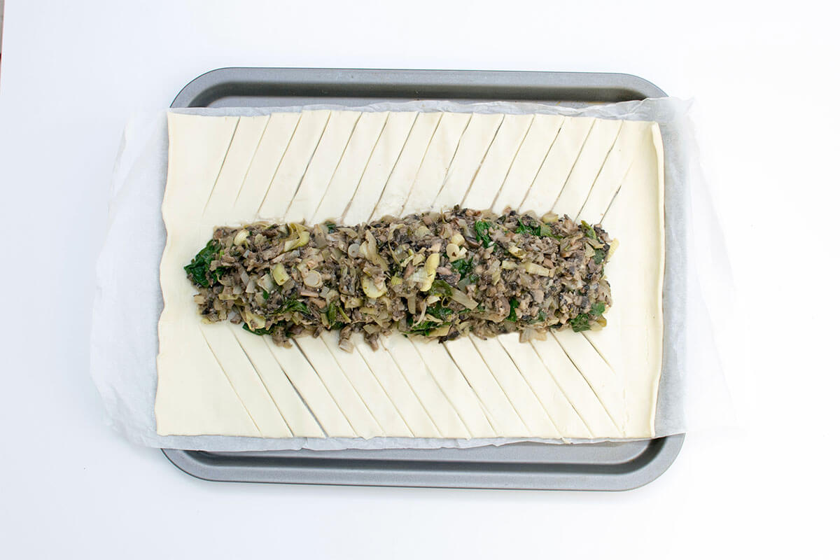 Rolled pastry with mushroom mixture in the middle of it